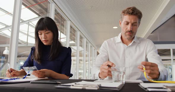 Two colleagues preparing name tags at a business conference