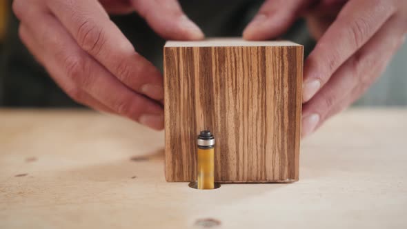 Close Up of Craftsman Hands Sanding the Surface of Handmade Wooden Box with Abrasive Paper Man