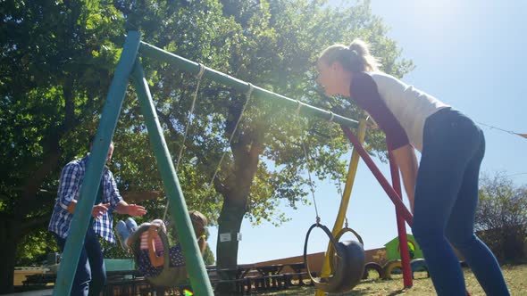 Family playing in the playground 4k