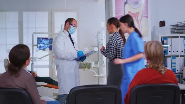 Doctor Taking Notes on Clipboard About Patient