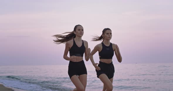 Beautiful Two Ladies Running on the Beach Side
