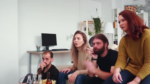 Two Male and Two Females Watching a Scary Movie