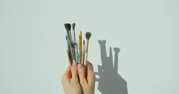 Paint Brushes in the Hand of Painter.