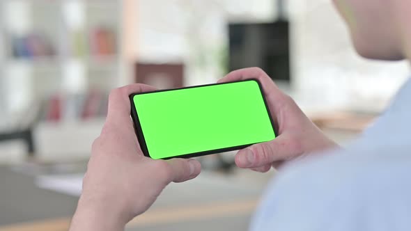 Watching Video on Horizontal Chroma Key Smartphone, Close Up