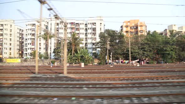 View on urban landscape during the train ride in Mumbai.