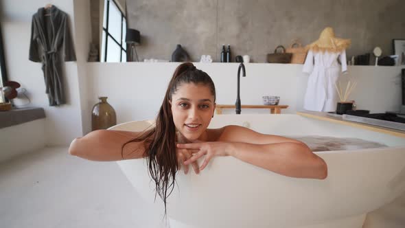 Relaxed Lady Taking Bath Enjoying and Relaxing While Lying in Bathtub