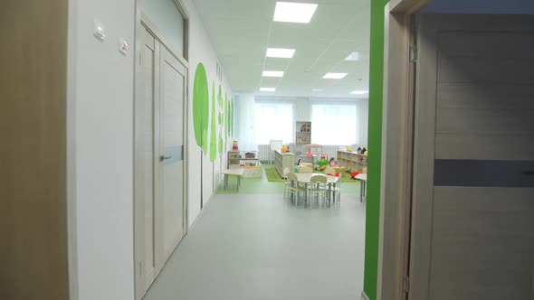 Large Tables for Craft and Racks with Toys in Playroom