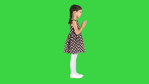 Little Girl in Polka Dot Dress Clapping Her Hands on a Green Screen Chroma Key