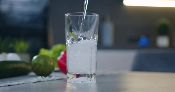 Transparent Glass that is Filled with Fresh Water on the Kitchen Background