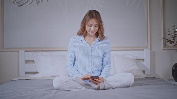 Camera Zoom in Cheerful Woman in Bedroom