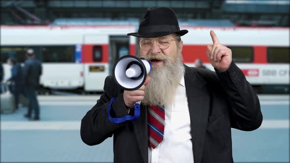 Senior Businessman Making an Announcement Through Megaphone