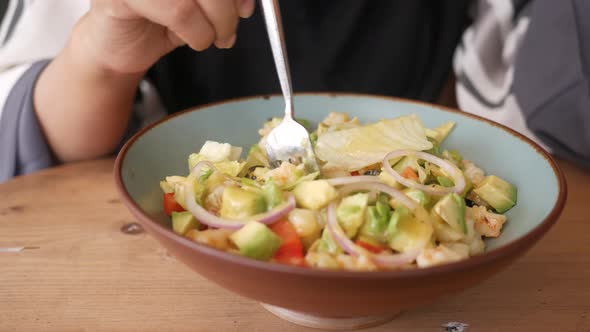 Young Women Eating Avocado Salad