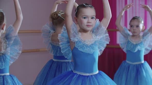 Ballet Training  Four Ballerina Girls in Blue Dresses Spinning on the Spot