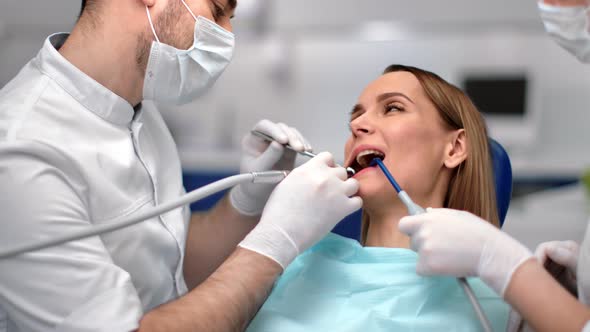 Girl Client at Dental Armchair During Cure By Medical Staff