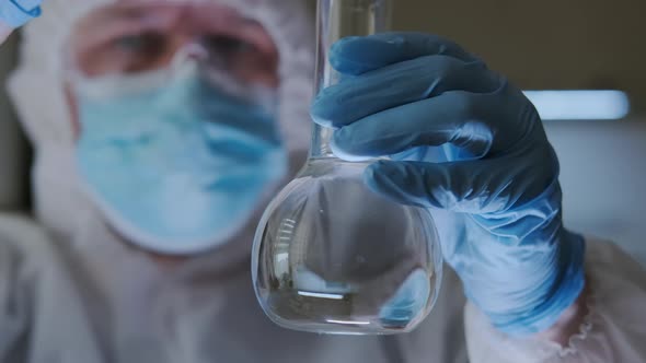 Laboratory Assistant Scientist Laboratory Tests Chemicals for Reactions in Flask