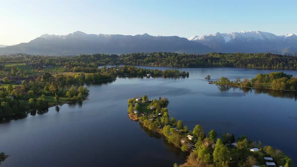 Flight over the campig island of Buchau in lake Staffelsee in Bavaria, Germany