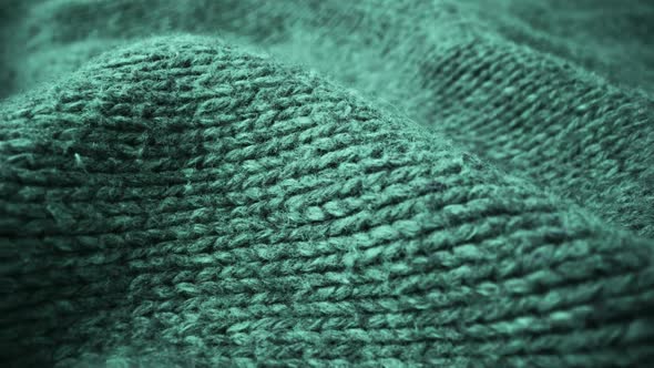 Extreme detail view of sheep wool cloth texture flowing in macro dolly shot.