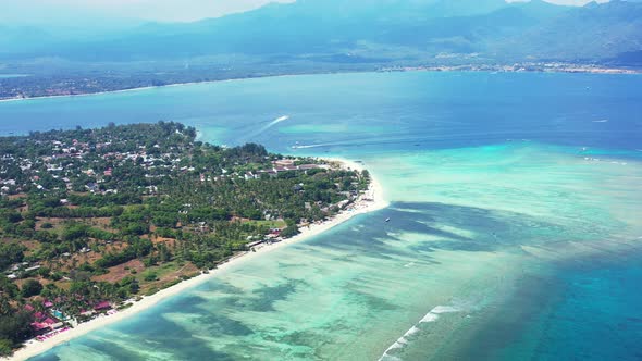 Tropical birds eye clean view of a sunshine white sandy paradise beach and aqua blue ocean backgroun
