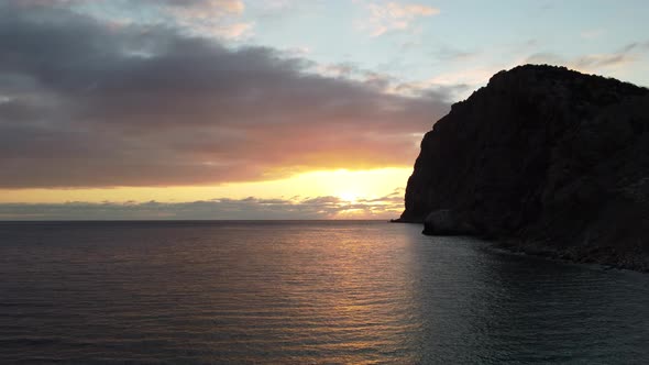 Aerial Panoramic View of Beautiful Sunset Above Calm Azure Sea and Volcanic Rocky Shores