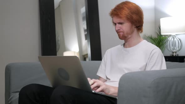 Angry Yelling Redhead Man Working on Laptop in Bedroom