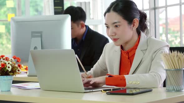 Business People Working at Table in Modern Office