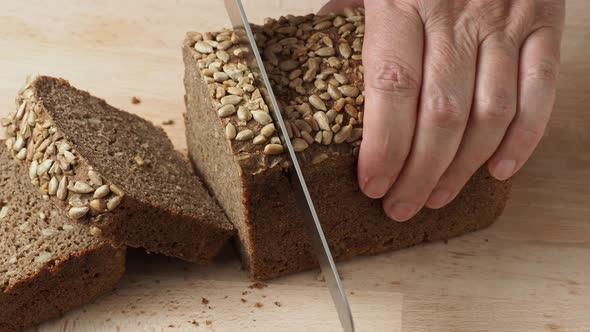 Cutting of bread with sunflower seeds