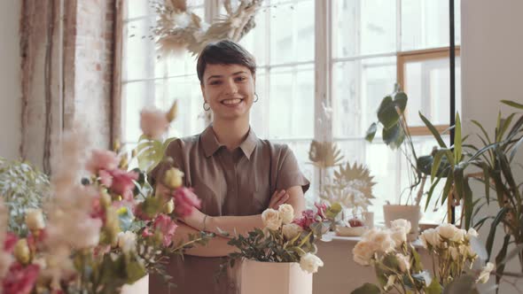 Young Happy Female Florist Posing for Camera at Work