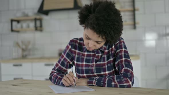 Focused African American Woman Working on Documents