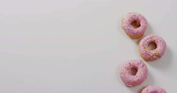 Video of donuts with icing on white background