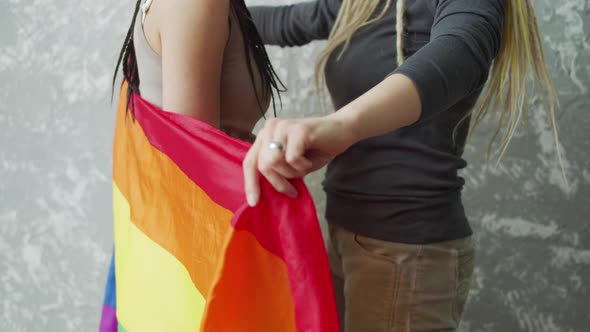 A Girl Covers Her Girlfriend By a LGBTQ Flag and Then Pulls to Herself