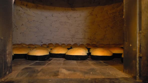 Rustic old retro oven that has lot of bread in it.