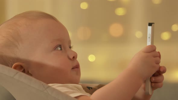 Child Watching TV in Living Room Cute Baby Boy Holding Tv Remote Sitting in Rocking Chair