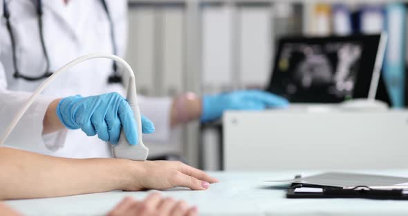 Ultrasound Technician Examines Wrist and Hand Bones of Young Woman