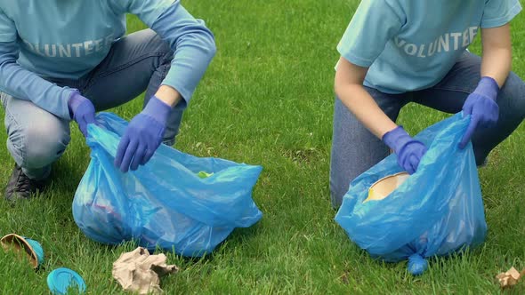 Couple of Volunteers Picking Litter in Park, Environmental Preservation, Ecology