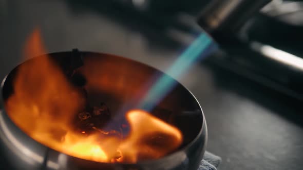 Red Chili Peppers and Herbs Spices with Fire on Modern Kitchen in Restaurant