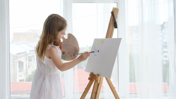 Preteen Girl with Easel at Home