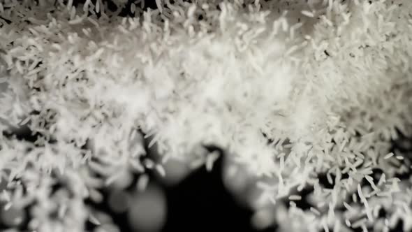 White Rice Grains Bouncing and Falling Down on Black Background Seeds Flies After Being Exploded