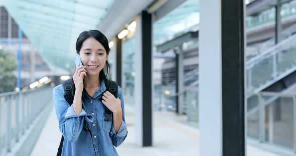 Woman talk to cellphone in the evening 