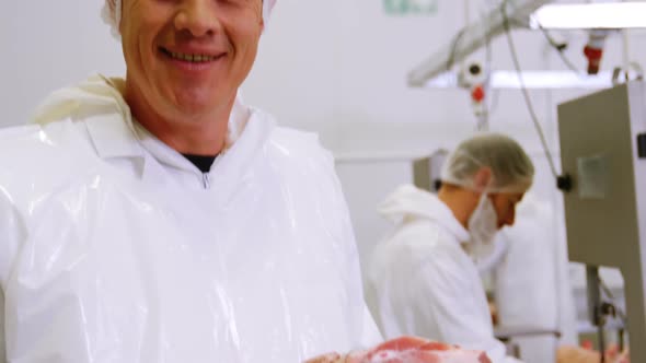 Butcher holding red meat