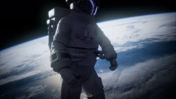 Astronaut in Outer Space Against the Backdrop of the Planet Earth
