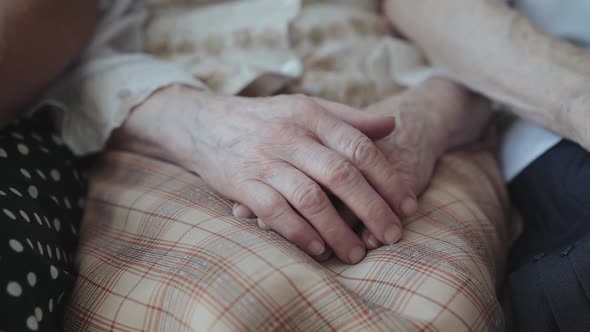 Close View of Putting Old Exhausted Female Hands on Hands Together at Camera