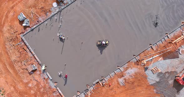 Workers are Using Concrete Polishing Machines for Cement After Pouring Concrete on the Foundation