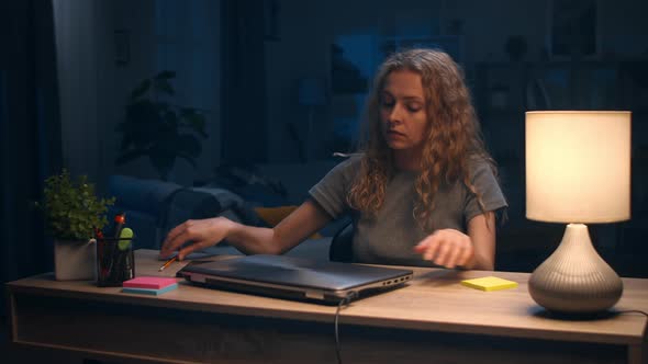 Young Woman Finished Work on Laptop at Home at Night