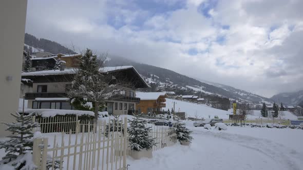 Man walking bu houses on a winter day