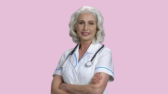 Beautiful Smiling Doctor Woman on Pink Background.