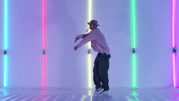 Dancing Man Young Talented Street Dancer Performing Freestyle Hip Hop Moves Against Bright Neon