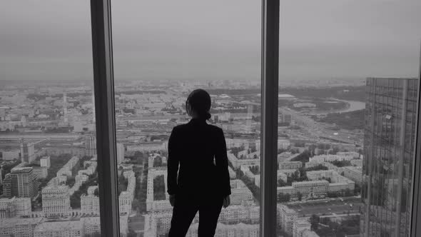 Silhouette of a Business Man Against the Window of a Skyscraper