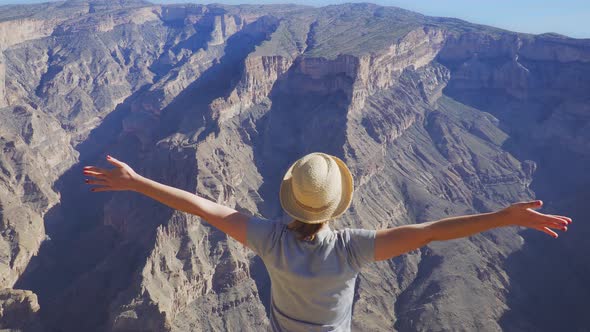 Young Foreign Female Tourist Enjoying the View of Wadi Ghul Aka Grand Canyon of Oman in Jebel Shams