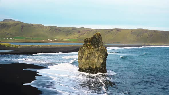 Iceland. Colorful warm sunset over the sea and volcanic basalt rocks.