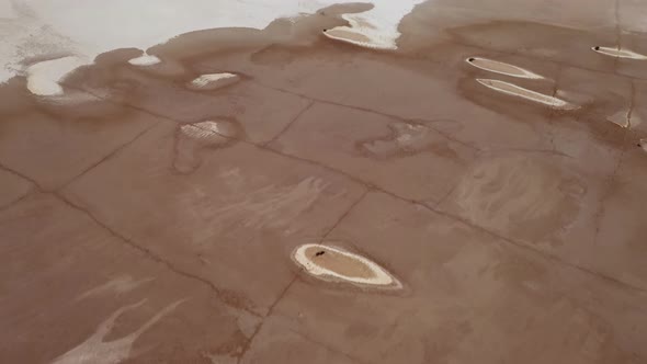 Willcox Playa aerial of strange pattern and textures on a dry lakebed, tilt-up reveal